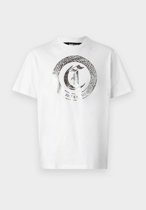 White cotton t-shirt featuring a large silver circular graphic with a snake and "JUST CAVALLI" text in the center. Short sleeves, crew neck.