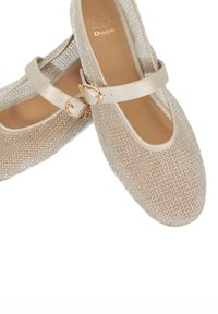 Beige mesh ballet flats with a rounded toe, ankle strap, and gold buckle detail. Smooth inner lining and textured exterior pattern.