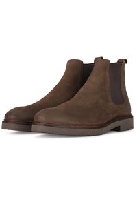 Stivaletti Chelsea in suede marrone con pannelli elasticizzati ai lati, punta tonda e suola testurizzata. Presentano un bordo cucito attorno alla suola.