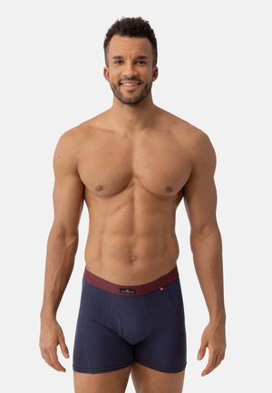 Boxershorts in navyblau mit burgunderfarbenem Bund. Aus weichem Material, mit schmaler Passform und Fronttasche mit Nahtdetails.