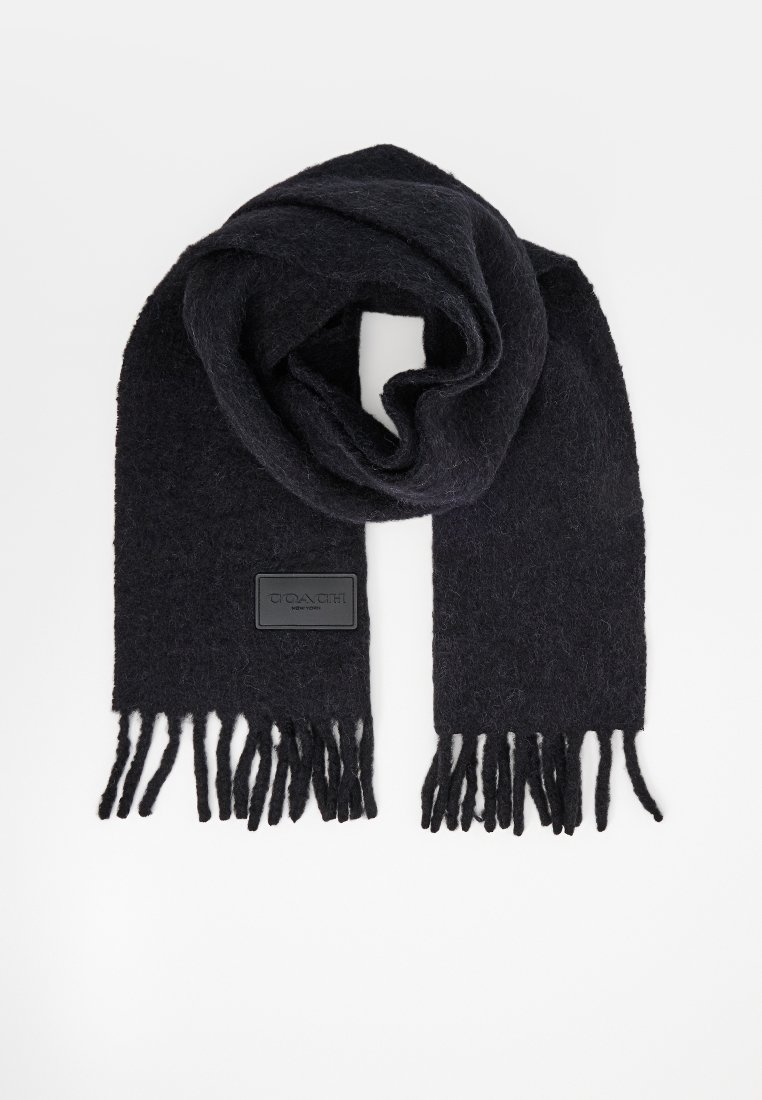 Écharpe en laine noire avec une finition texturée, ornée d'un patch logo et de bords frangés pour plus de détails. Tissu doux et chaud.