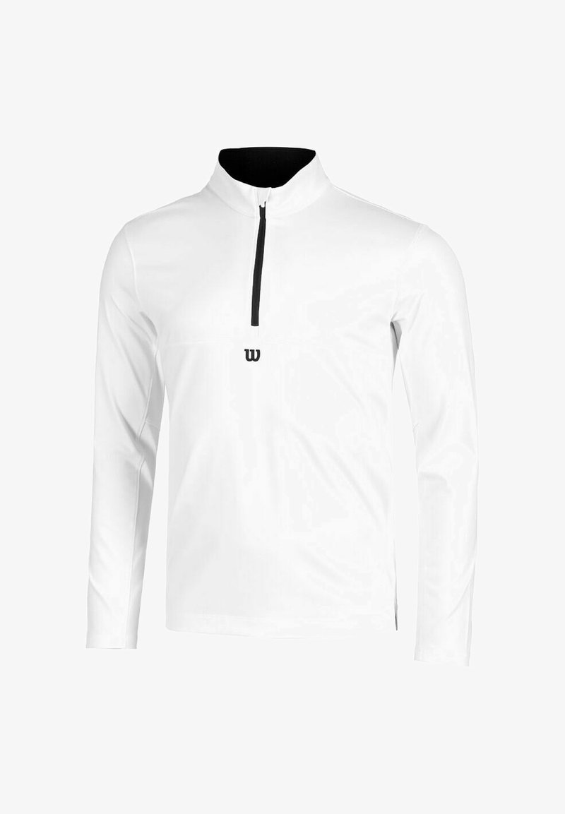 Chemise blanche à manches longues avec col noir à demi-fermeture éclair, comportant un petit logo noir sur le devant et un tissu lisse et léger.