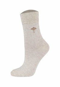 Calcetín de algodón color beige claro con un puño acanalado, que presenta un pequeño y sutil logo marrón cerca del tobillo. Textura suave y longitud estándar hasta el tobillo.