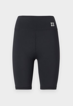 Shorts de cycliste taille haute noirs avec une coupe ajustée et un petit logo blanc "HUGO" sur le côté gauche de la ceinture.