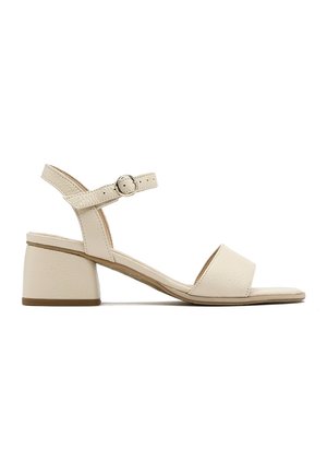 Beige sandal med åben tå, lav blokhæl og ankelrem, der er fastgjort med en lille rund spænde.