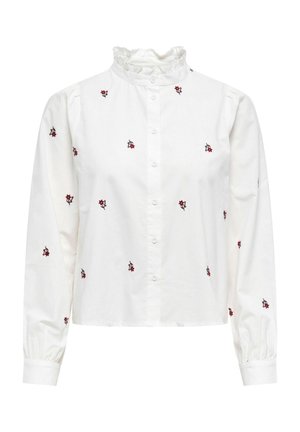 White long-sleeve button-up blouse with ruffled collar and small red floral embroidery scattered across fabric.