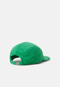 Green corduroy baseball cap featuring a slightly curved brim and adjustable strap at the back. Textured surface with ventilation eyelets.