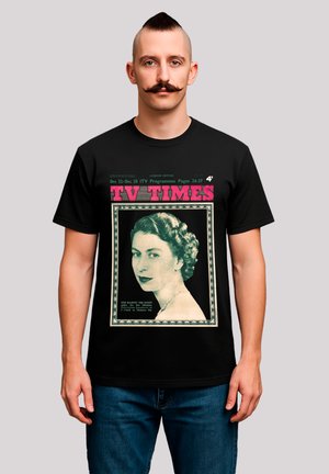 Black t-shirt featuring a vintage magazine cover print of a woman's portrait, with pink "TV TIMES" text and a decorative border.