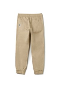 Beige sweatpants met een elastische tailleband, twee achterzakken en elastische boorden bij de enkels. Voorzien van een "CHAMPS" label op de achterzak.