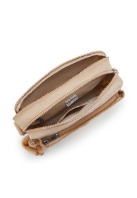 Beige handbag with zippered compartments, textured exterior, and plush pom accent. Inside features lining and label visibility.