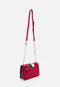 Rotes Crossbody-Bag mit verstellbarem Ledertragegurt, goldenen Kettendetails, Rückenzipperfach und gemusterten Seitenflächen mit Logodesign.