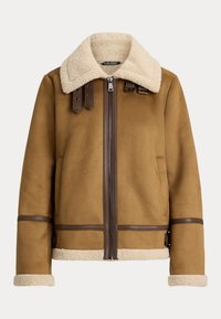 Giacca in shearling marrone con un morbido colletto crema, chiusura con zip, dettagli in pelle e due tasche frontali con dettagli marroni sui polsini.