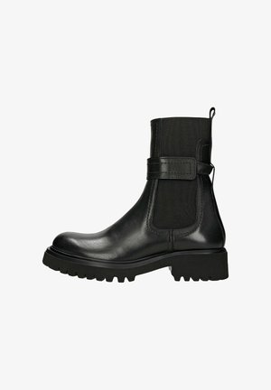Black ankle boots with a smooth leather exterior, textile side panels, a thick rubber sole, and a buckle accent on the outer side.