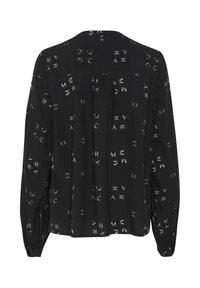 Must have musta pika varrukaga blouse valgete geomeetriliste mustritega, tagaküljel volt, nööpidega mansetid, valmistatud kergest kangast.