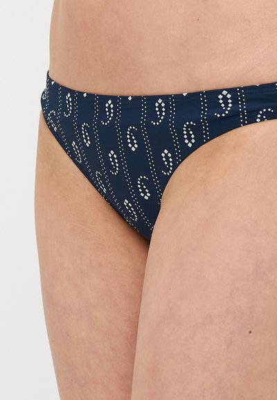 Parte de baixo de biquíni azul-marinho com um padrão branco repetido de pontos e curvas. Textura suave com corte de cintura média e interior forrado.