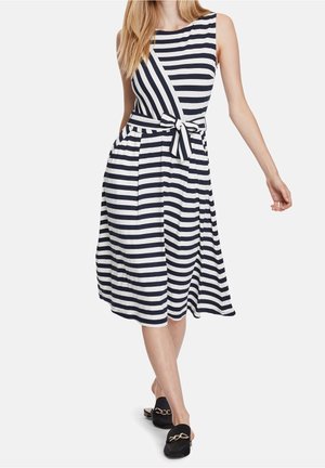 Ärmelloses Kleid in Marineblau und Weiß mit gestreiftem Design, gebundenem Taillenband und fließendem Rock. Hergestellt aus weichem Stoff, mit seitlichen Taschen und rundem Ausschnitt.