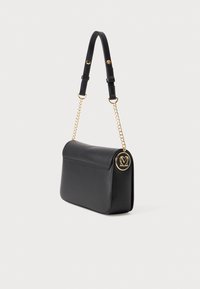 Black leather handbag with gold-tone chain and logo accent. Features a structured shape, flat flap, and adjustable strap.