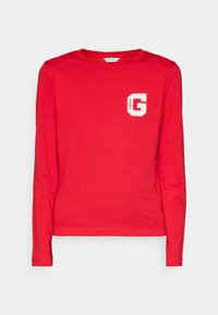 Rode lange mouwen t-shirt gemaakt van zachte katoen. Kenmerkt een wit logo accent op de linkerborst. Ronde hals en rechte zoom.