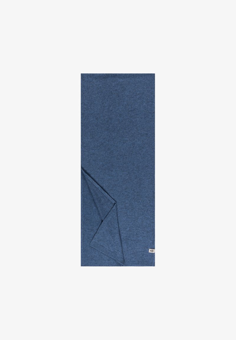 Blaue gestrickte Decke mit strukturiertem Finish. Der Stoff ist weich, mit einer gefalteten Ecke und einem kleinen Markenetikett am Rand.