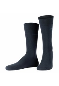 Calcetines de algodón negros con puños acanalados, textura suave y sin patrones ni acentos visibles. Adecuados para uso casual o formal.