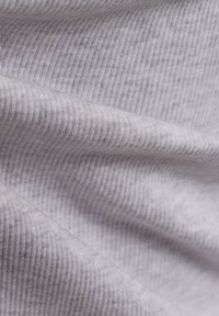 Light gray ribbed fabric with a soft texture, showing distinct vertical lines and gentle folds, suggesting flexibility and stretch.