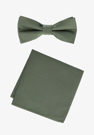 Olive green fabric bow tie and matching folded pocket square on white background.