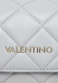 Quiltan usnjeni ročni torbici v sivi barvi z zlatim logotipom "Valentino", ki se ponaša z gladko teksturo in značilnim šivanim diamantnim vzorcem.