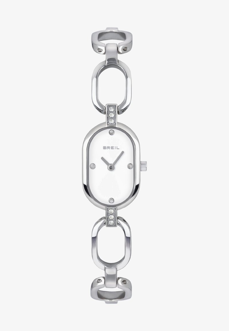 Montre en argent avec un cadran blanc ovale, bracelet à maillons et cristaux d'accent. Affiche un design minimaliste et un mouvement à deux aiguilles.