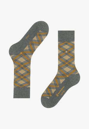 Graue Socken mit einem Rautenmuster in Beige- und Orangetönen, hergestellt aus einem strukturierten Material, mit einem Logodetail in der Nähe der Zehen.