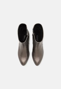 Μποτίνια ankle σε μεταλλικό γκρι δέρμα με μυτερή μύτη και λεία υφή, διαθέτοντας φερμουάρ στο πλάι για εύκολη εφαρμογή.