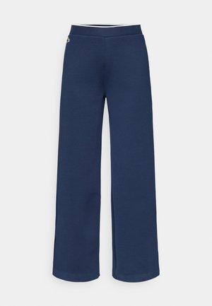 Pantalones de pierna ancha en color azul marino hechos de tela suave, con cintura ajustada y aberturas laterales para un detalle adicional. Diseño limpio sin estampados.