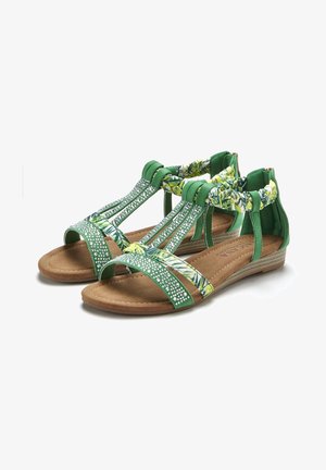 Green sandals with decorative straps, featuring floral patterns and rhinestone accents. Textured footbed and low wedge sole for comfort.
