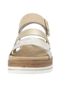 Strappy sandals with a beige and metallic gold color scheme. Features a flexible sole, textured straps, and a decorative side buckle.