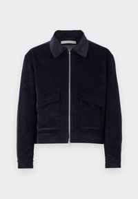 Navy corduroy jacket with a zip closure, classic collar, two front pockets, and a cropped design. Textured fabric with wide ribbing.
