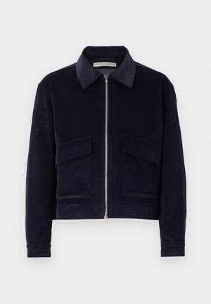 Navy corduroy jacket with a zip closure, classic collar, two front pockets, and a cropped design. Textured fabric with wide ribbing.