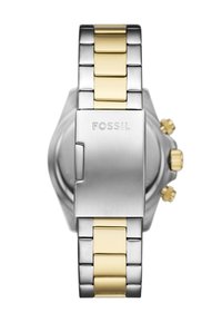 Montre en acier inoxydable avec des accents en or jaune. Elle présente un bracelet maillon, une finition métallique brossée et un cadran rond avec plusieurs boutons.