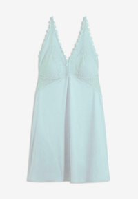 Slip azzurro chiaro con parte superiore in pizzo, dotato di spalline regolabili e una parte inferiore fluida e svasata. Fantasioso bordo in pizzo lungo il décolleté.