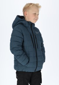 Blue quilted puffer jacket with a hood, featuring black zippers and accents. Two front zippered pockets and a textured, warm fabric.