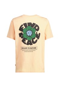 Vaaleanoranžilta puuvillapaidoilta, joissa on suuri musta ja vihreä kukkakuva takana, jossa on valkoiset tekstit "LÖYDÄ RAUHASI" ja "PAET Luontoon."