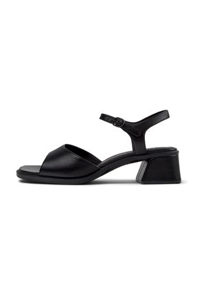 Black leather sandal with a rounded open toe, an ankle strap featuring a buckle, and a short block heel. Smooth texture and minimal design.