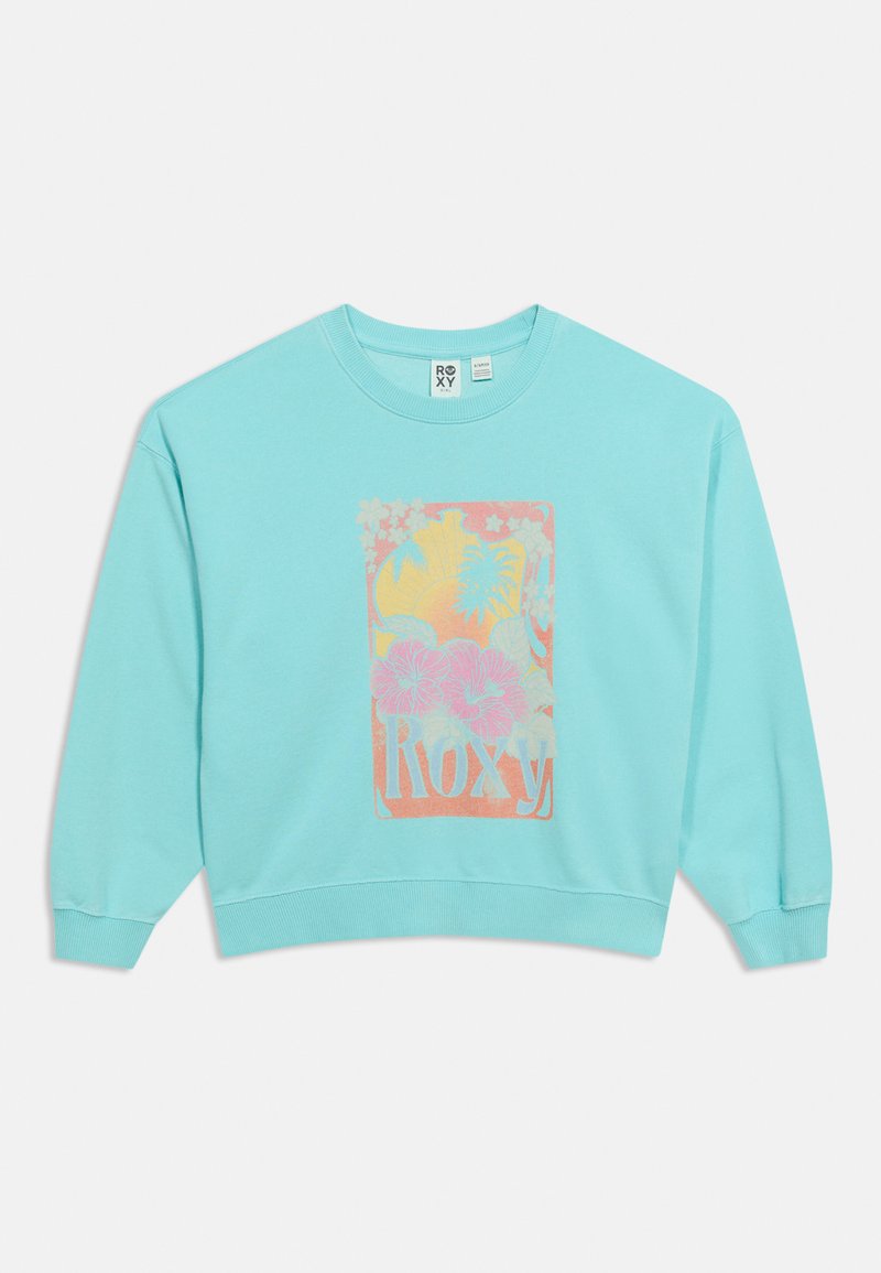 Sweatshirt bleu clair à manches longues, poignets et ourlet côtelés, avec un imprimé floral rose et jaune et le texte « Roxy ».