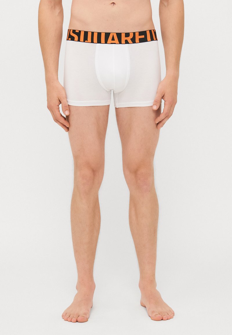 White boxer briefs with an elastic black waistband featuring orange text. The fabric appears smooth with a fitted design.