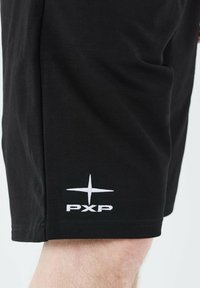 Black cotton shorts with a smooth texture, featuring a white embroidered "PXP" logo and star design on the lower hem.