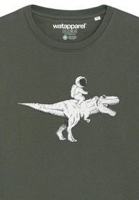 Donkergroen katoenen T-shirt met een witte graphic van een astronaut die op een Tyrannosaurus rex rijdt, wat het onderscheidende ontwerp en het speelse motief benadrukt.