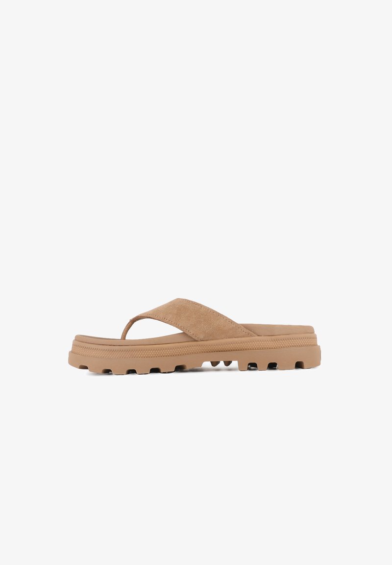 Bruna flip-flopsandaler med mockaremband, en tjock gummiknoppa med grova mönster för grepp och en minimalistisk design utan utsmyckningar.