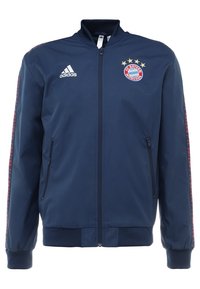 Navy blue zip-up jacket with a standing collar. Features Adidas logo and FC Bayern Munich emblem on the chest, side zip pockets, and striped accents.