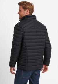 Black puffer jacket with horizontal quilting, high collar, and branded sleeve. Textured, lightweight material, suitable for cold weather.