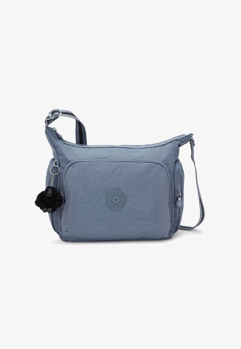 Borsa a tracolla blu con tasca frontale con zip, tracolla regolabile a righe, tasche laterali e un piccolo portachiavi morbido nero attaccato.
