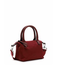 Red fabric handbag with double handles, detachable shoulder strap, and silver hardware. Features a zipper closure and bow accent on the side.