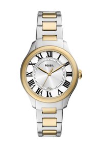 Montre Fossil avec un bracelet en métal argenté, des accents dorés, un cadran blanc et des chiffres romains. Elle dispose d'une fenêtre de date à 6 heures et d'un boîtier rond.